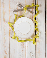 measuring tape on a wooden background. diet concept