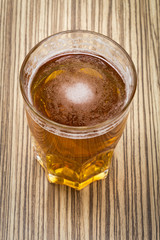  beer in the glass and covers on wooden table