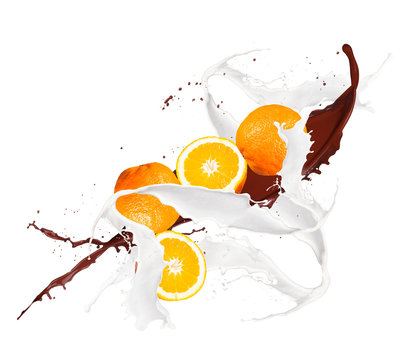 Fruit, orange in milk splash, isolated on white background