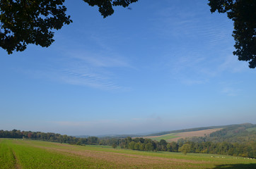 Obraz premium Rural landscape with meadows and fields on rolling hills in Wallonia on sunny autumn day, Durnal, Yvoir
