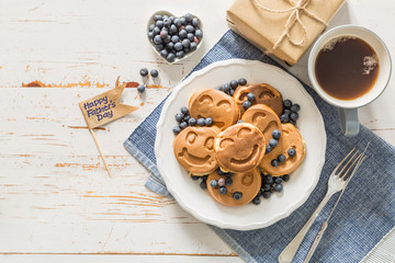 Fathers day concept - pancakes with blueberries and gift