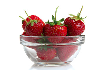 a bunch of ripe delicious strawberries in glass bowl on white isolated background