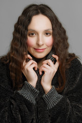 young fashion model in eco fur coat holding the collar