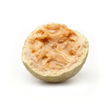 One half  of a cracked Organic Limonia or Kaitha (Limonia acidissima) isolated on white background.
