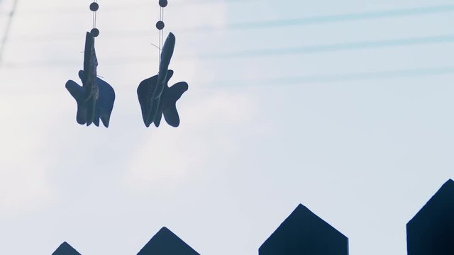 silhouette of a decorative mobile hanged against the door on a Sunshine Day 4k