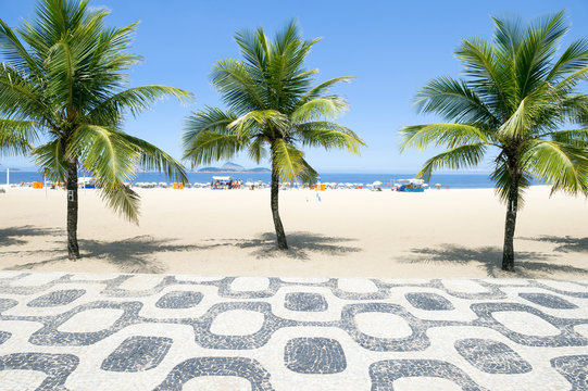 Classic empty view of the Ipanema Beach boardwalk with palm trees and blue sky and no people in Rio de Janeiro, Brazil