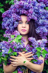 Beautiful girl in lilac flowers.