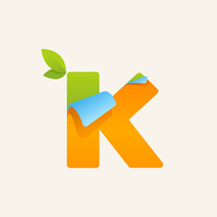 K paper letter logo with green leaves icon.