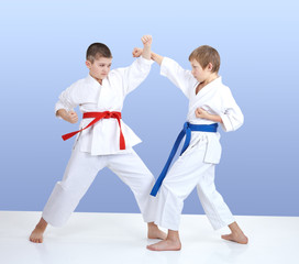 Paired exercise karate are training two boys