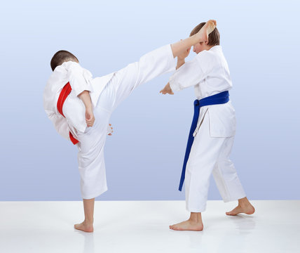 Kick leg and block athletes doing in karategi