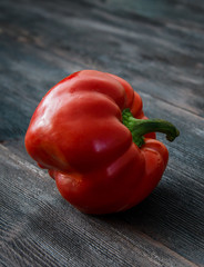 Juicy red pepper on a wooden table