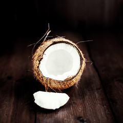 close up of a coconut on a wooden background with copy space