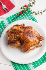 Baked chicken on white plate.
