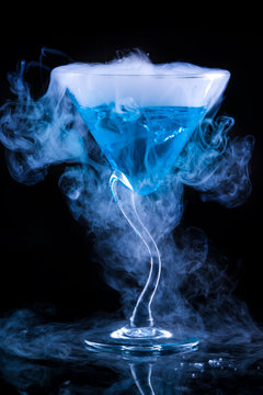 blue cocktail with splash and ice vapor