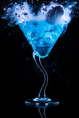 blue cocktail with splash and ice vapor