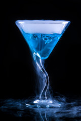 blue cocktail with splash and ice vapor