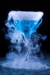 blue cocktail with splash and ice vapor