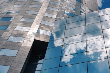 Business building with cloud reflections.