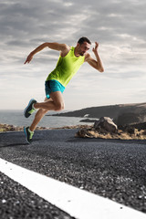 Male runner sprinting during outdoors training for marathon run