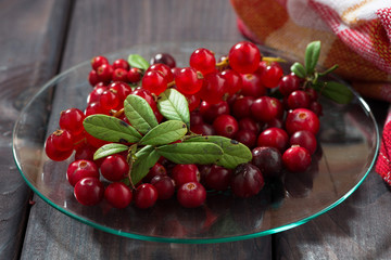 cowberries and red currants in a glass plate