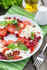 fresh salad with tomatoes, cottage cheese, mint pesto