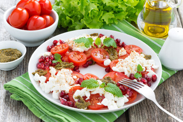 fresh italian salad with tomatoes, cottage cheese, pesto 