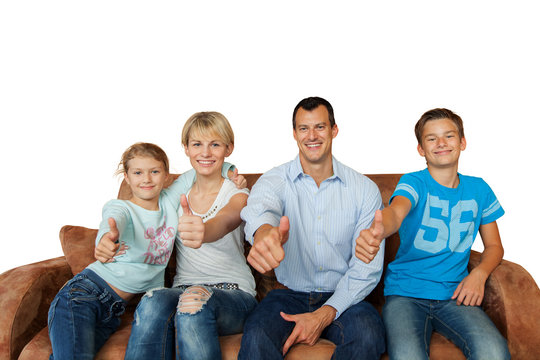 Thumbs up - happy family on a couch isolated on white