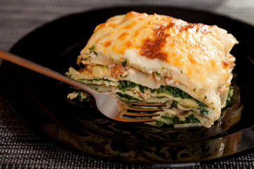 Typical Italian lasagna with spinach and salmon