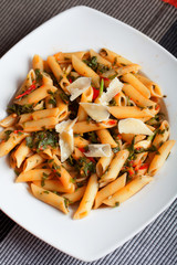 Penne with fresh herbs and parmesan cheese.Shot from above