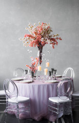 Wedding decoration for banquet with sakura and candles for six person