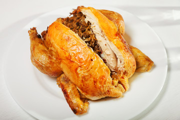 Baked whole chicken stuffed with rice. Horizontal shot.