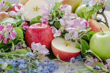 Apple and pears in spring bouquet with flowers, focus view
