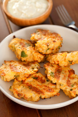 Deep fried zucchini croquettes. Shot from above in a white plate. Vertical shot