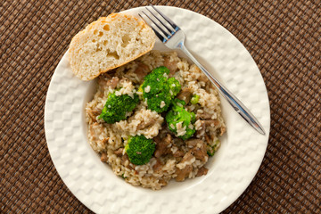 Slow cooked dish with chicken tights, rice and broccoli. Shot from above.