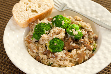 Slow cooked dish with chicken tights, rice and broccoli.