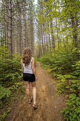 pretty teenage girl hiking outside in the summer