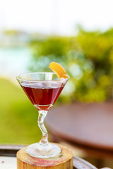 Glasses of cocktails on bright background