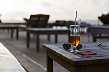 glass of beer on a table at the pool