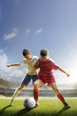 Obraz na płótnie Canvas Childrens are playing soccer on grand arena