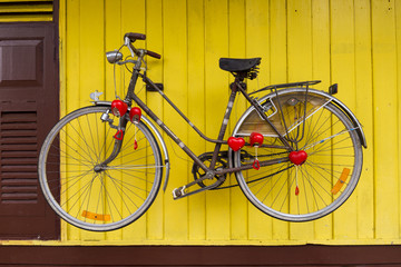Fototapeta na wymiar old bicycle on Yellow Background