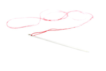 Small needle with thread isolated over the white background