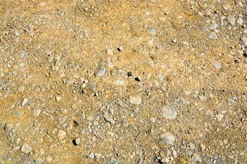 texture of light tan sand and stones