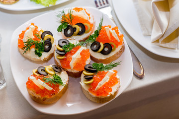 red caviar on french bread with olive and dill