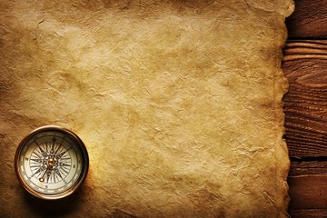 Close up view of the Compass on the old paper background