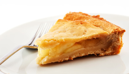 A slice of apple pie on a white plate