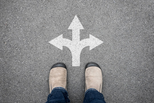 Brown shoes standing at crossroad