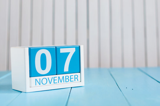 November 7th. Image of november 7 wooden color calendar on blue background. Autumn day. Empty space for text