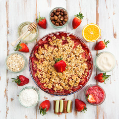 Rhubarb and Strawberry crumble with all ingredients nearby
