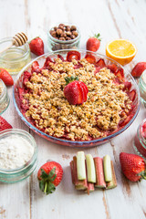 Rhubarb and Strawberry crumble with all ingredients nearby