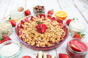 Rhubarb and Strawberry crumble with all ingredients nearby